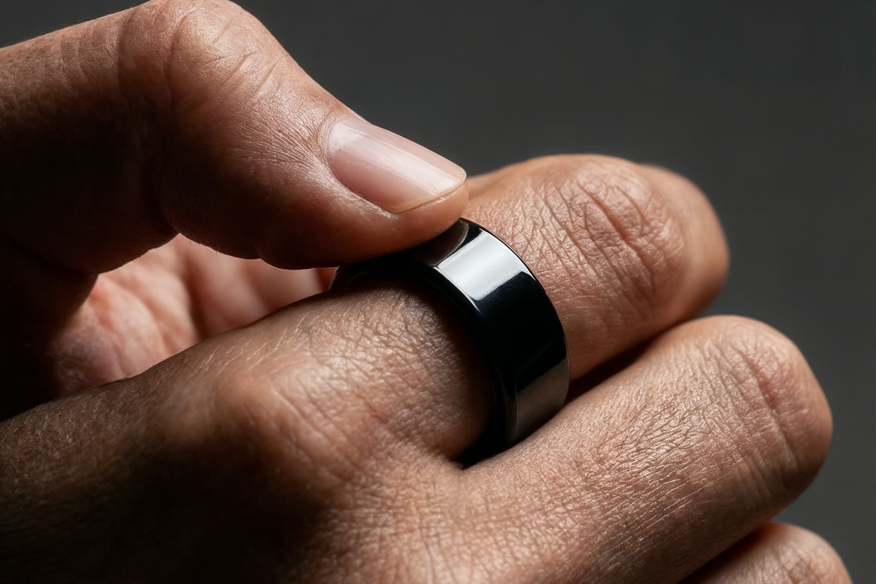 Close-up of a hand wearing the Magic Ring in Black.